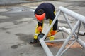 Worker using electric grinder Metal sawing with flashing sparks. The worker cuts off a piece of pipe Royalty Free Stock Photo