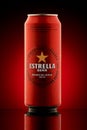 Kiev, Ukraine, 27.04.2020: Metal can beer Estrella Damm, Barcelona 1876. Red and beautiful reflections, highlights, on a red Royalty Free Stock Photo