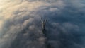 Thick clouds of autumn fog and the Motherland monument sticking out of them Royalty Free Stock Photo