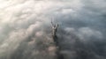 Thick clouds of autumn fog and the Motherland monument sticking out of them Royalty Free Stock Photo