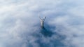 Thick clouds of autumn fog and the Motherland monument sticking out of them Royalty Free Stock Photo
