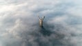 Thick clouds of autumn fog and the Motherland monument sticking out of them Royalty Free Stock Photo