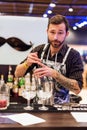 KIEV, UKRAINE - 30 OCTOBER, 2016: Barman festival. Young handsome bartender is making cocktail.