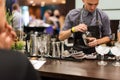 KIEV, UKRAINE - 30 OCTOBER, 2016: Barman festival. Young handsome bartender is making cocktail.