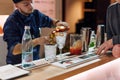 KIEV, UKRAINE - 30 OCTOBER, 2016: Barman festival. Young handsome bartender is making cocktail.