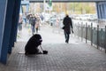 Kiev, Ukraine - October 24, 2018: Beggarly old woman sits on the sidewalk surrounded Royalty Free Stock Photo