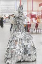 Kiev, Ukraine, October 2020: girl in a queen costume made of polished pieces of metal at the international furniture exhibition