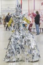Kiev, Ukraine, October 2020: girl in a queen costume made of polished pieces of metal at the international furniture exhibition