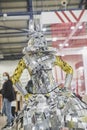 Kiev, Ukraine, October 2020: girl in a queen costume made of polished pieces of metal at the international furniture exhibition