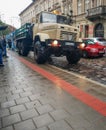 KIEV, UKRAINE - OCTOBER, 24 2018 people awaiting on a bus stop for tram, which is dragged by a truck Royalty Free Stock Photo