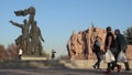 People on a walk at the Peoples` Friendship Arch in Kiev.