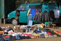 Street illegal trade. Open-air clothing market. Cargo van and old worn items for sale