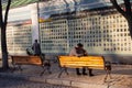 Kiev, Ukraine - October 14, 2018: Young couple is sitting on a bench near the alley in memory of the soldiers