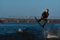 31.03.19. Kiev, Ukraine, Podil. The guy rides a wakeboard in protective wetsuit on the river.