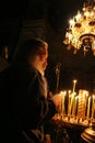 Kiev, Ukraine, 04.09.2005 The priest with a gray beard is lighting candles