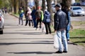 Kiev, Ukraine, 11.04.2020: A queue of people wearing medical masks at the entrance to the store for food. Everyone washes their Royalty Free Stock Photo