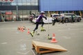 Rollerblading street competition between children. In line skater small boy is virtuoso jumping. City sport life Royalty Free Stock Photo