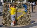 Kiev, Ukraine - September 20, 2015: : Boy weaves scrim with national symbols