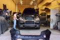 Kiev, Ukraine - September 2, 2016: Car service. Masters in the garage repair Porsche Cayenne