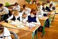 Kiev Ukraine 1 September 2018. Happy children in school uniform write in the classroom while sitting at their desks. Studying Royalty Free Stock Photo