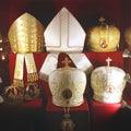 Headdresses of priests on a red background