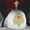 Headdresses of priests on a red background