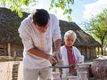 KIEV, UKRAINE - SEPTEMBER 18, 2016: man and boy making clay pot