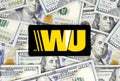 Western Union logo printed on paper, cut and placed on money background