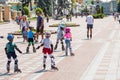 Kiev, Ukraine the 8th of July - A group of children in sport equipment with instructor doing rollerskating exercises in Mariinsky