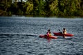 Kiev, Ukraine, 10.06.2020: Two girls in a canoe-polo helmet rowing with weights and swimming on water. canupolo. in the