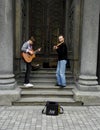 04.18.2019 Kiev Ukraine. Two street musicians. One guitarist, and the second violinist on the background of the doors of the synag Royalty Free Stock Photo