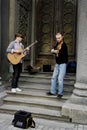 04.18.2019 Kiev Ukraine. Two street musicians. One guitarist, and the second violinist on the background of the doors of the synag Royalty Free Stock Photo