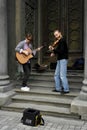 04.18.2019 Kiev Ukraine. Two street musicians. One guitarist, and the second violinist on the background of the doors of the synag Royalty Free Stock Photo