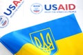 Kiev, Ukraine - 02 12 2023: USAid logo and ukrainian flag, USAid is USA agency for international development - assistance abroad Royalty Free Stock Photo