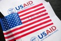 Kiev, Ukraine - 02 12 2023: USAid logo and US flag, USAid is USA agency for international development - assistance abroad, Royalty Free Stock Photo