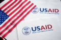 Kiev, Ukraine - 02 12 2023: USAid logo and US flag, USAid is USA agency for international development - assistance abroad Royalty Free Stock Photo