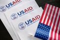 Kiev, Ukraine - 02 12 2023: USAid logo and US flag, USAid is USA agency for international development - assistance abroad Royalty Free Stock Photo