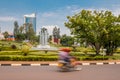 Kigali, Rwanda - September 20, 2018: A `moto` motorbike at a roundabout near the city centre, with Kigali City Tower in the back Royalty Free Stock Photo