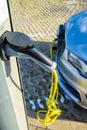 Electric hybrid car charging batteries at plug in charge station Royalty Free Stock Photo