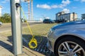 Electric hybrid car charging batteries at plug in charge station in the Netherlands Royalty Free Stock Photo