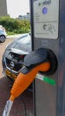 Nissan electric car charging batteries at plug in charge station in the Netherlands