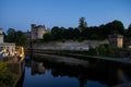 Kilkenny bridge and castle reflected in river at evening