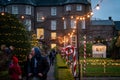 KILKENNY, IRELAND, DECEMBER 23, 2018: People in christmas market, waking along a decorated and illuminated path with festive new