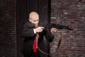 Killer in suit and red tie shoot a machine gun Royalty Free Stock Photo