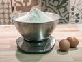 A kilogram of flour placed on electronic scales