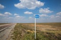 Kilometer mark on summer road and cloudy sky background Royalty Free Stock Photo