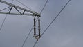 110 kilovolt Insulator on a Steel Lattice Pylon and Clouds