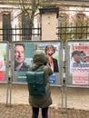 Rear view of woman taking photo of 2022 French presidential election with Les