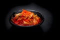 Kimchi on black dish on black background. Kimchi is the national dish of Koreans That is more popular.