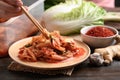 Korean food, Kimchi cabbage eating by chopsticks Royalty Free Stock Photo